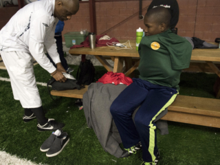 Malik and his father Tamba arriving at a recreational area where they play soccer every Thursday.