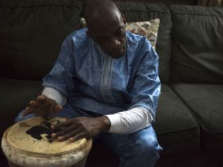 Tamba playing the djembe, one of West Africa's best known music instruments.