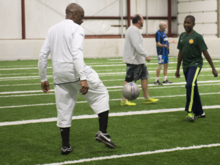 Malik and Tamba communicating through their bodies on the soccer field.