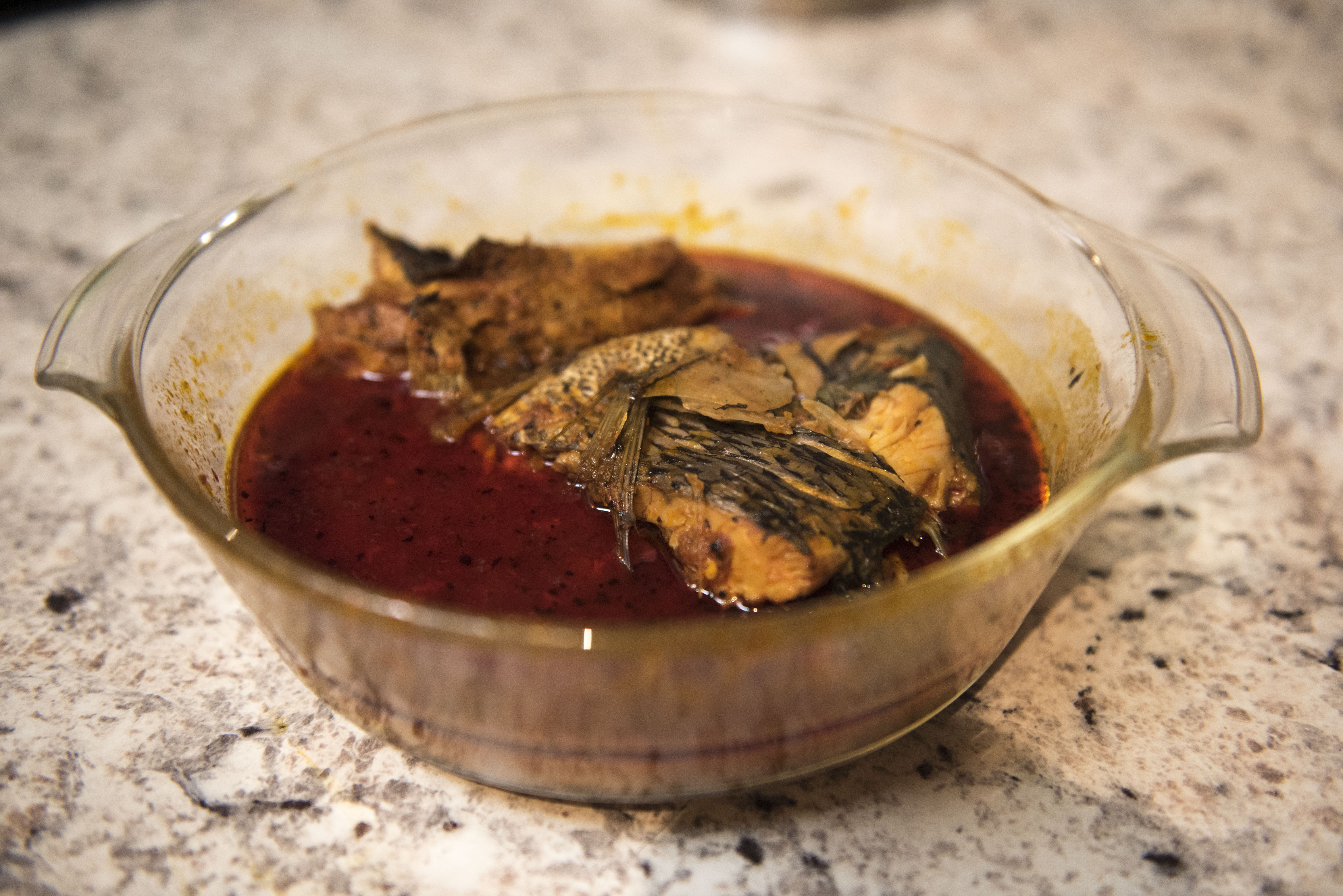 White fish stew, one of the many African meals prepared ahead by Malik’s mother before travelling to Guinea. Given their different schedules, Tamba and Malik are not used to sit and eat together.