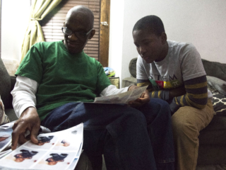 Tamba and Malik looking at Malik’s childhood pictures and reminiscing about their moments together.